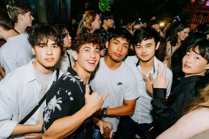 Group of students smiling at a night event