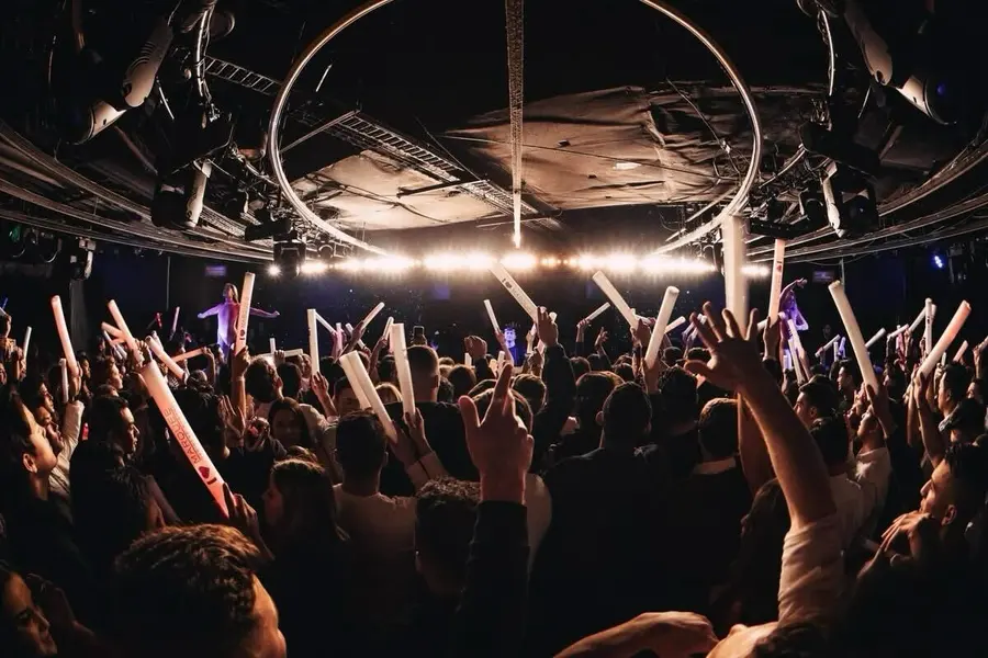 Crowd at a nightclub with a light show