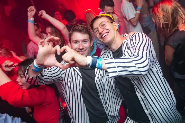 Two friends making a heart with their hands
